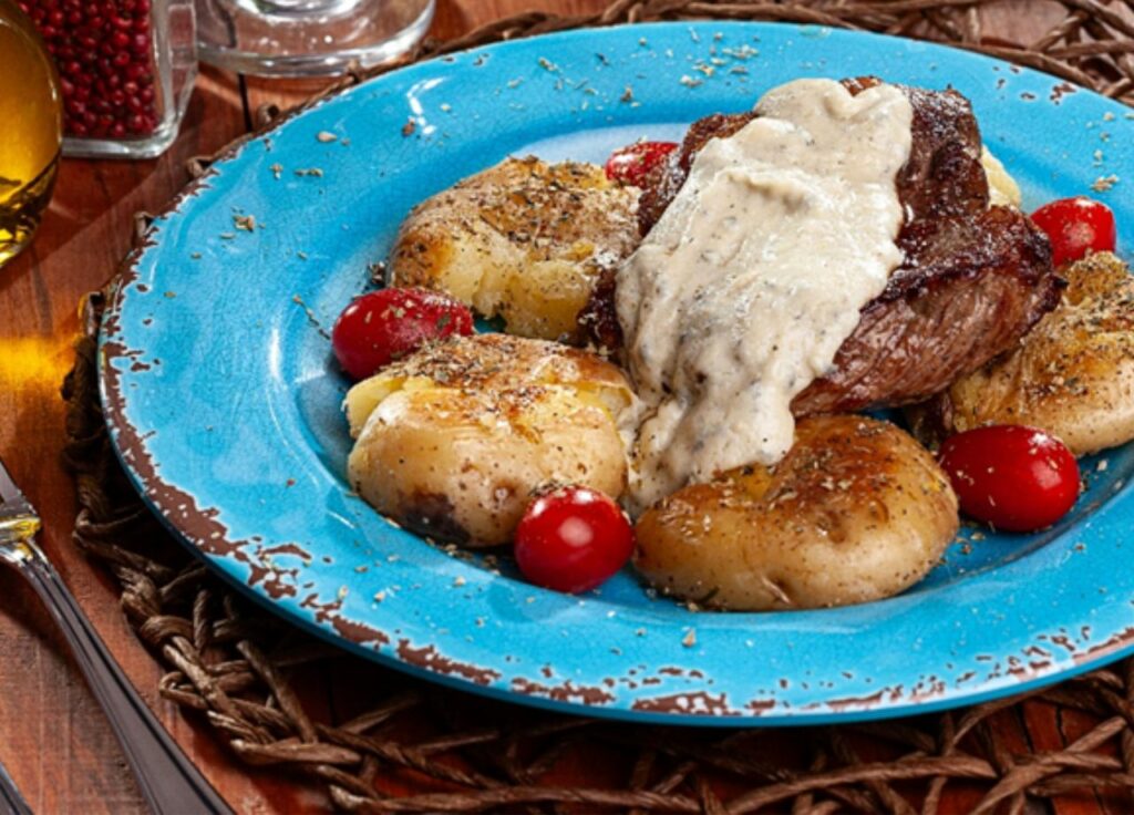 Bife Ancho ao molho gorgonzola com batatas ao murro